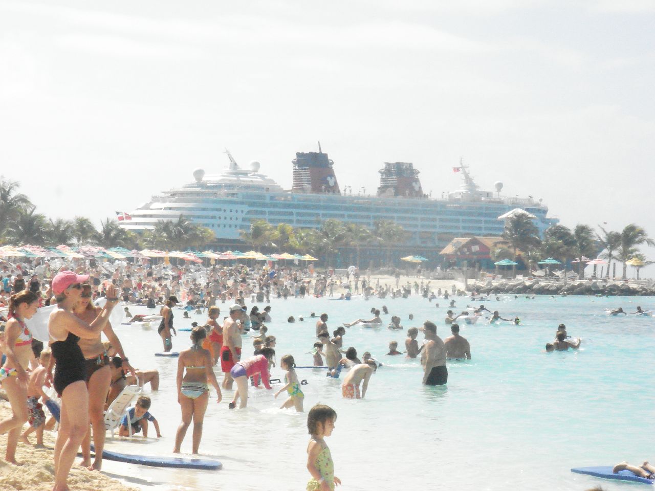 A family beach area at Disney's Castaway Cay with soft sand and calm water