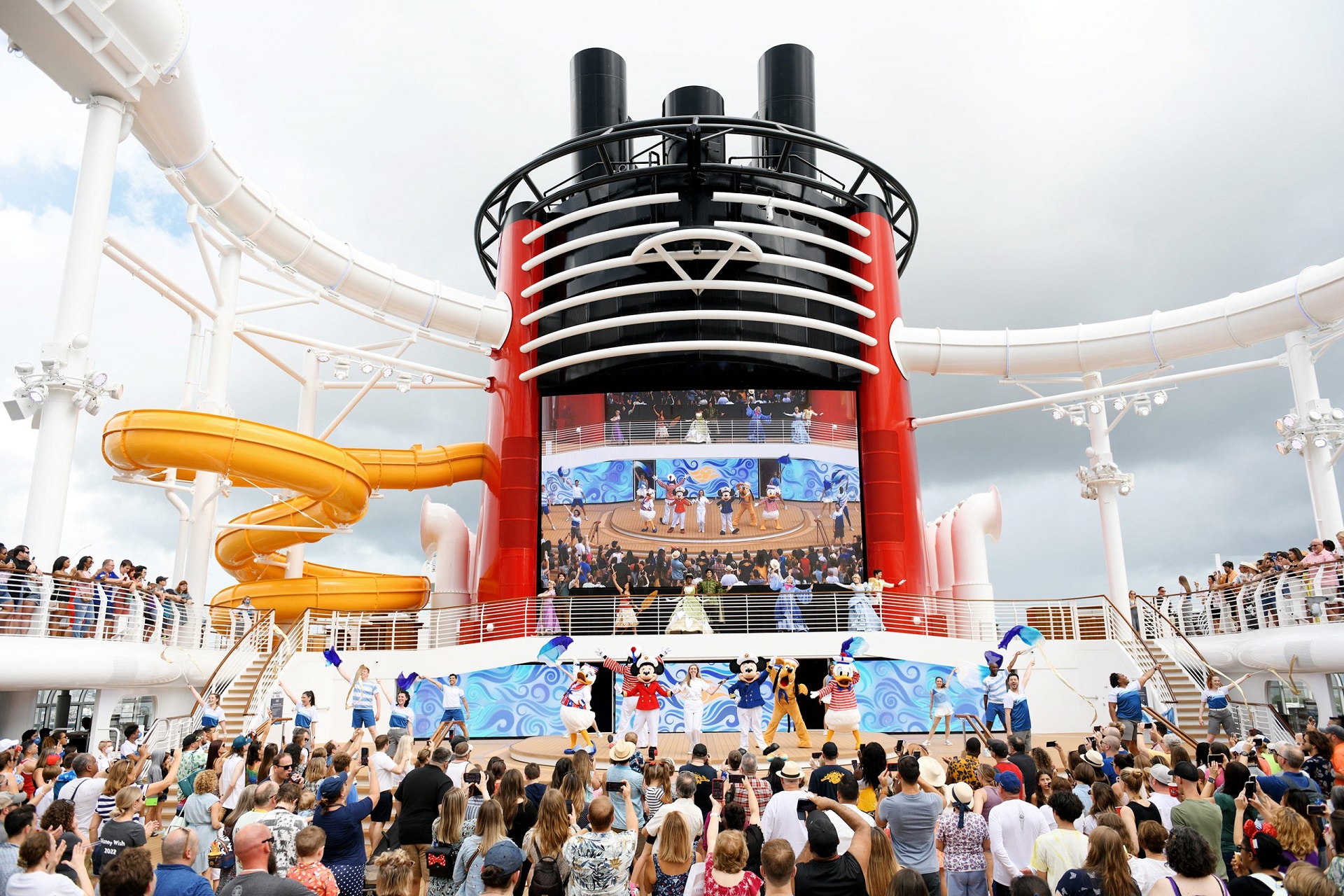 Families enjoying the Disney Wish cruise ship sail-away party on deck