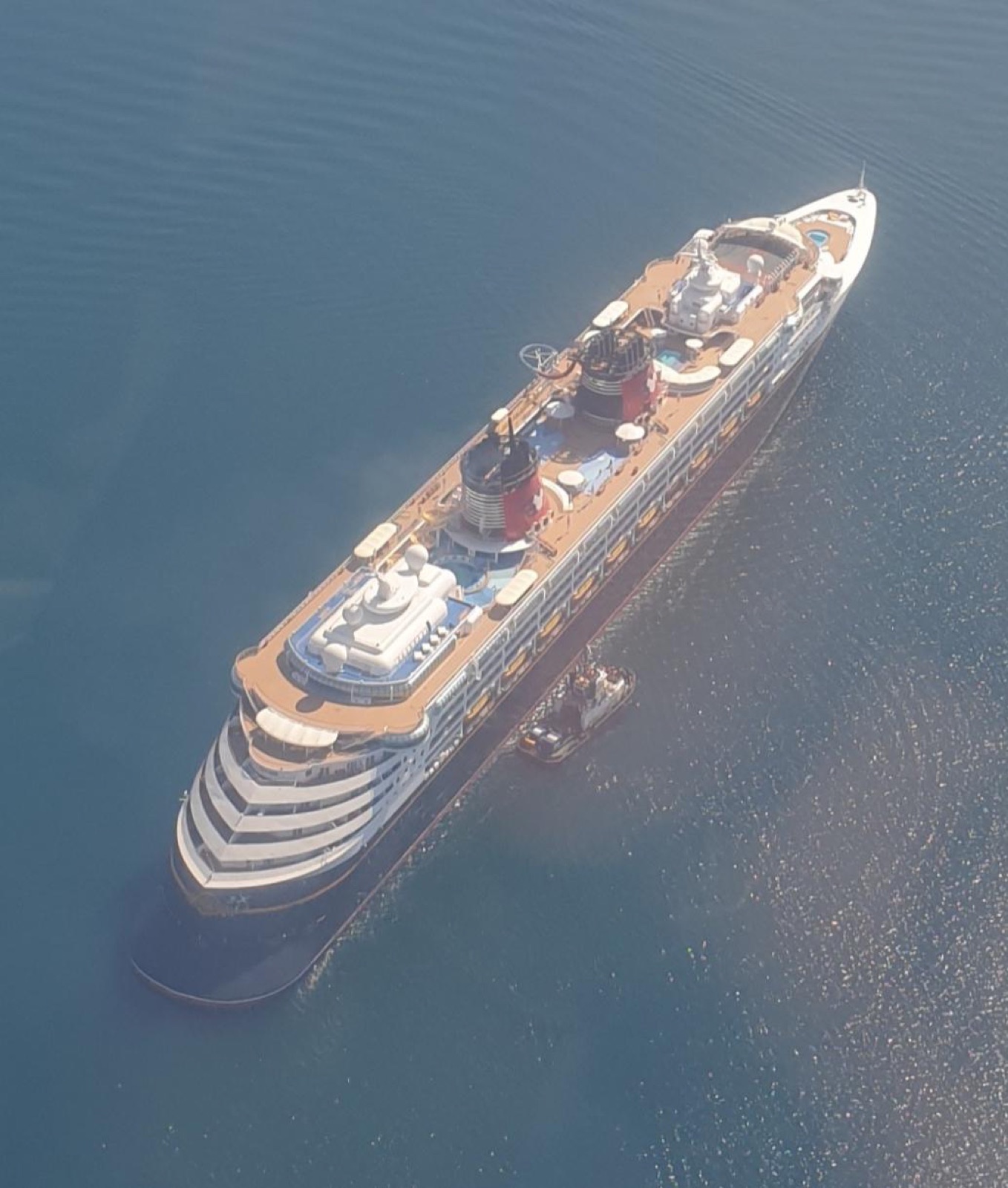 Aerial view of the Disney Magic cruise ship at anchor in calm blue water